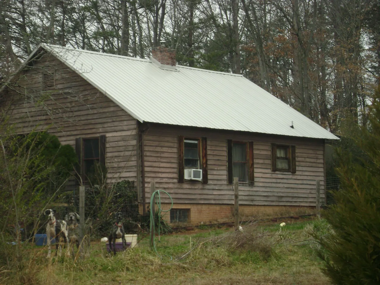 White metal roof on an old wood sided farmhouse, from a Metal Roof Installation job in Cresco